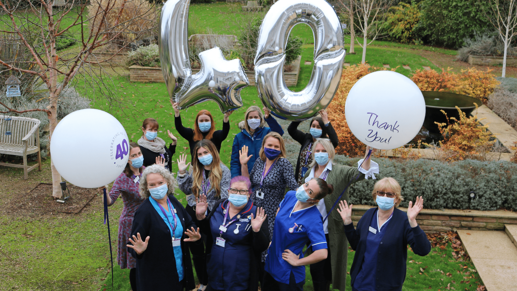 Rowcroft staff member celebrate Rowcroft 40th anniversary outside with balloons.