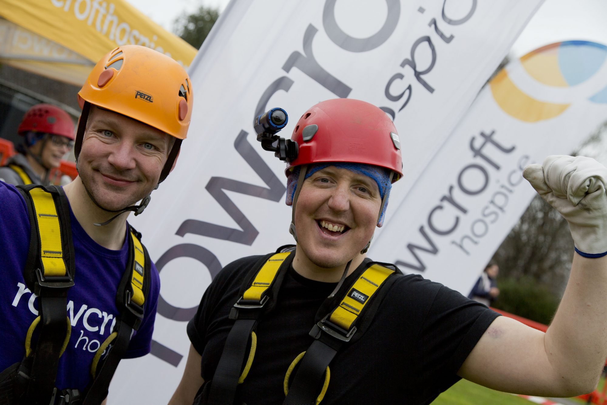 Two fundraisers pose with euorphria after completing an abseil.