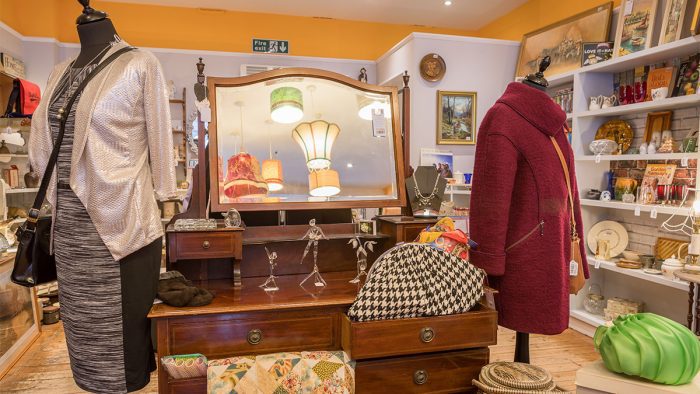 Some vintage clothing and a mirrored counter at Rowcroft's Babbacombe charity shop.