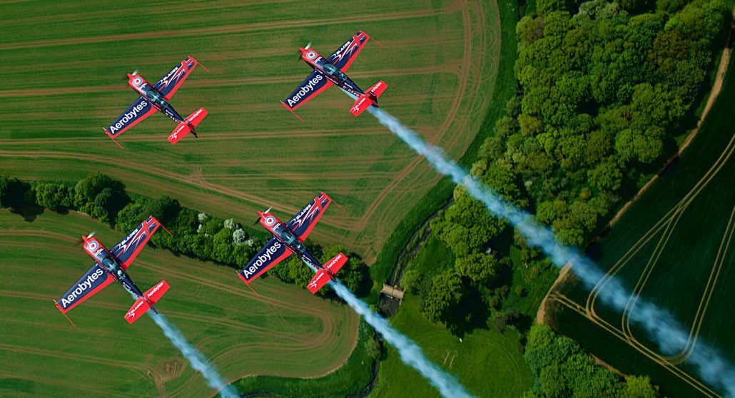 The Blades aerobatic team flying above green fields