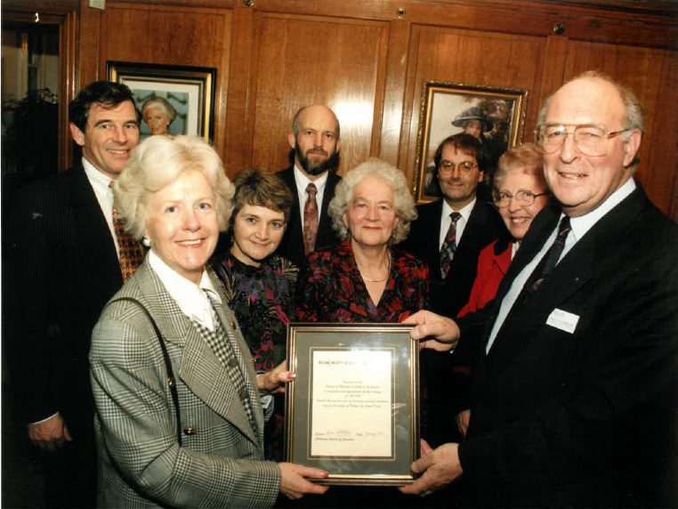 Bridget Tretheway receiving a plaque for the first million pounds raised by Friends of Rowcroft