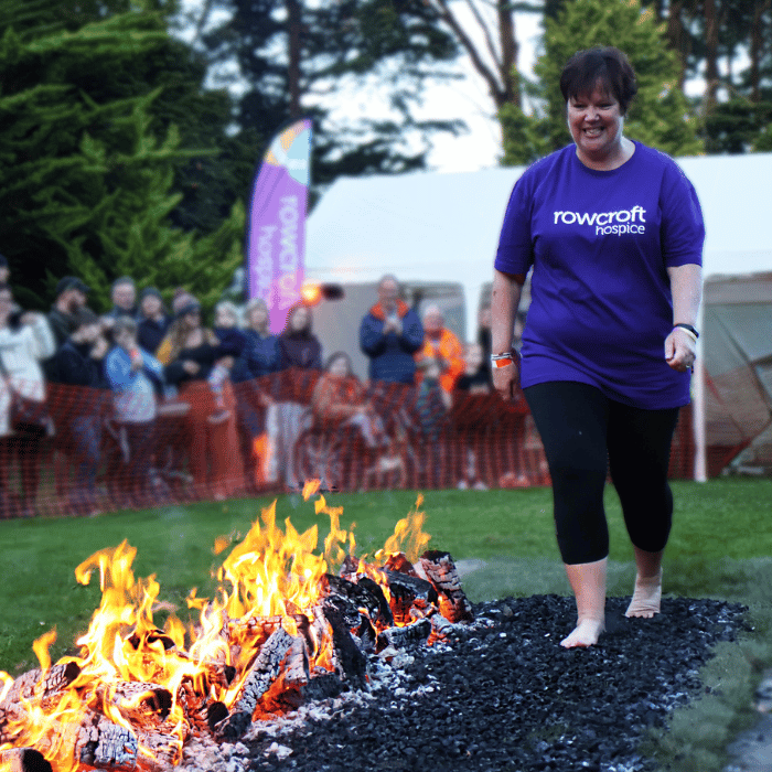 A supporter walks across hot coals for Rowcroft