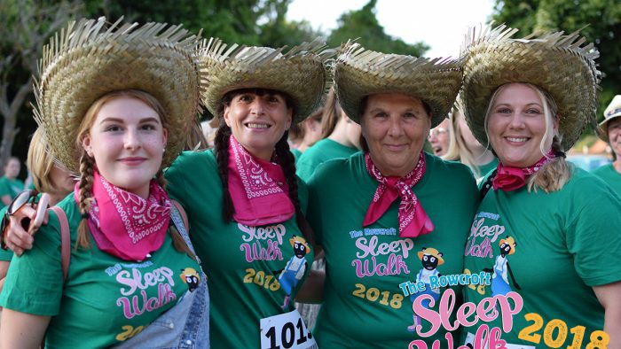 Participants in the Sleepwalk posed in green matching t-shirts with matching straw hats.