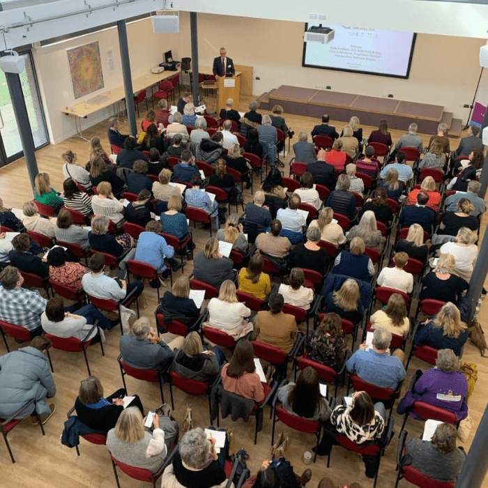 A room of people attending the conference.