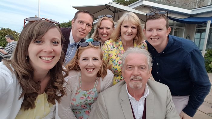 The Drein family pose at a wedding for a selfie.