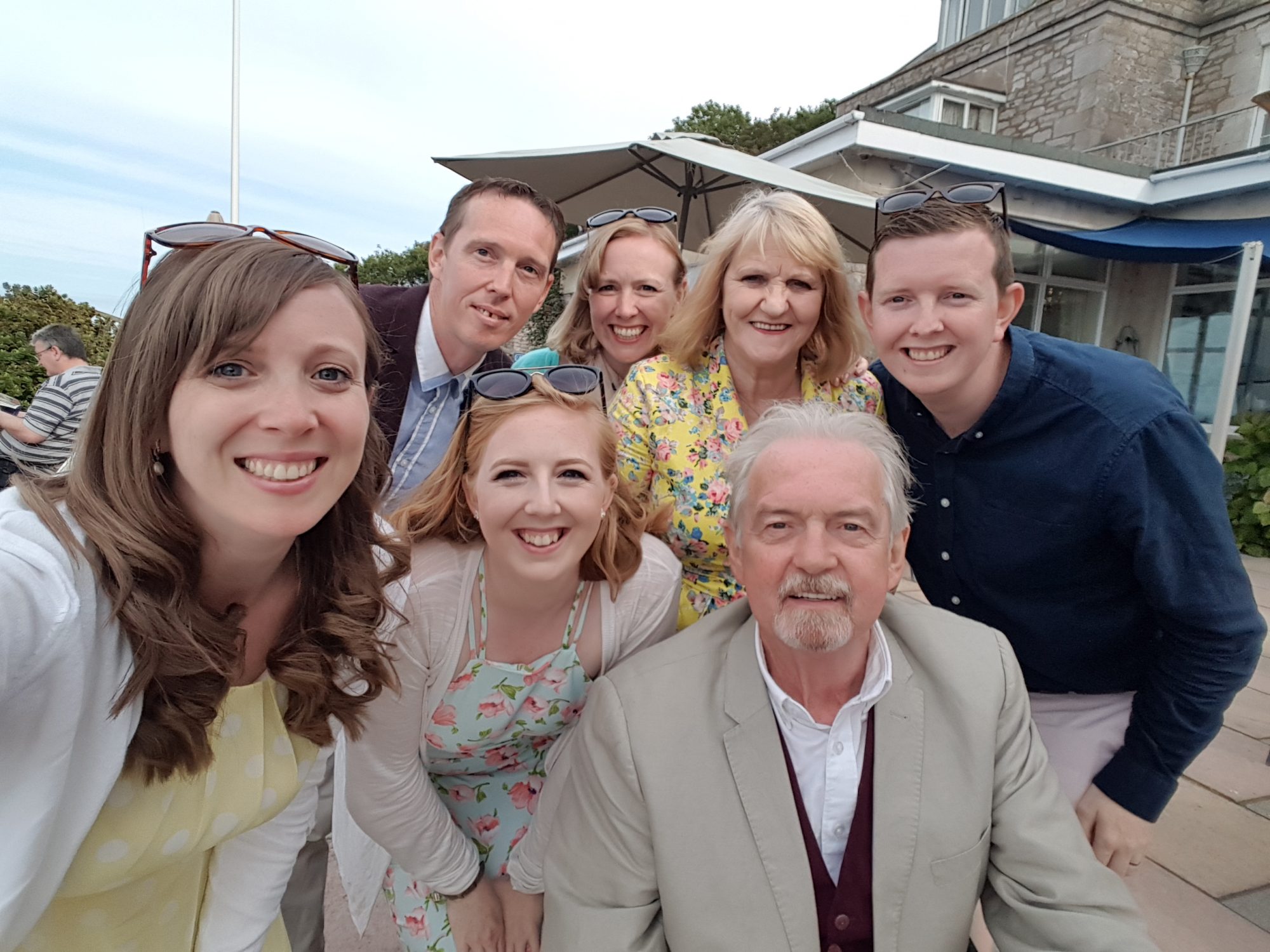The Drein family pose at a wedding for a selfie.