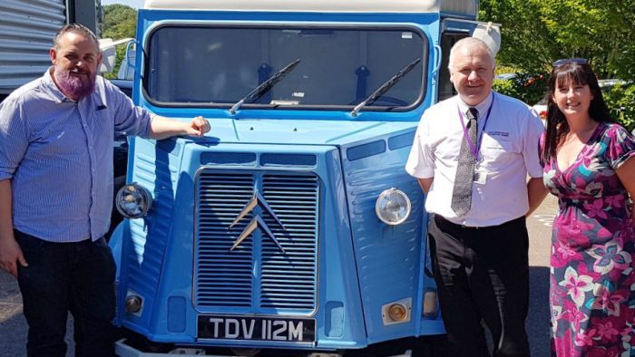 Ella's mobile Café van stands outside surrounded by Rowcroft staff.