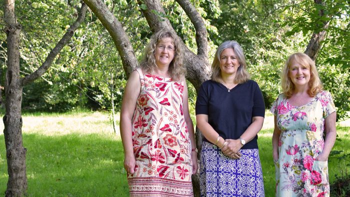 Rowcroft education team smile for a photo under a tree.