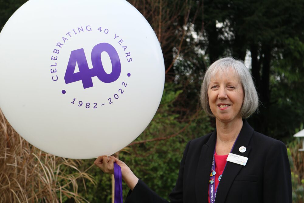 Dr Gill Horne holding a 40th Anniversary balloon