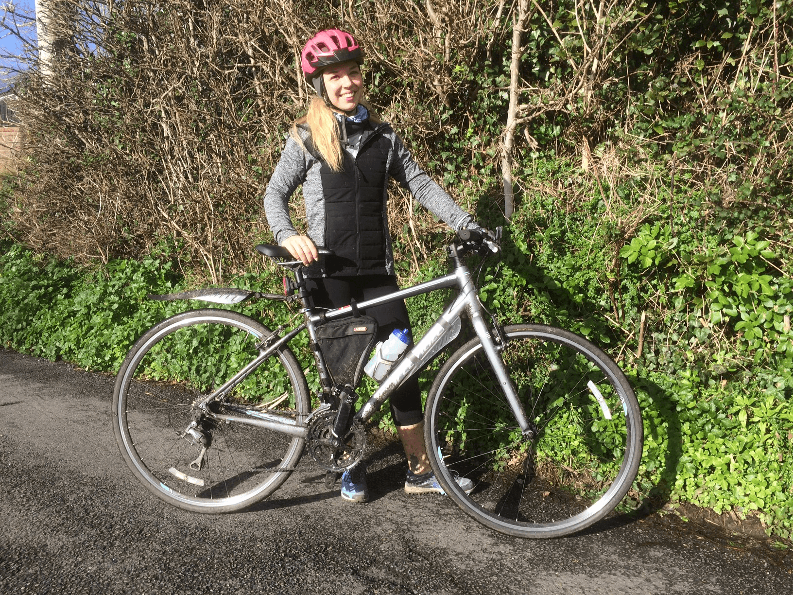 Heather Woolner poses outside with her bicycle as she takes on a cycling endurance challenge.