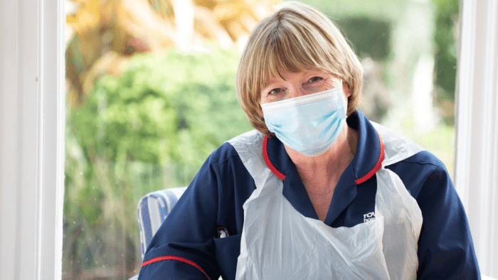 Rowcroft nurse, Claire smiles behind a mask.