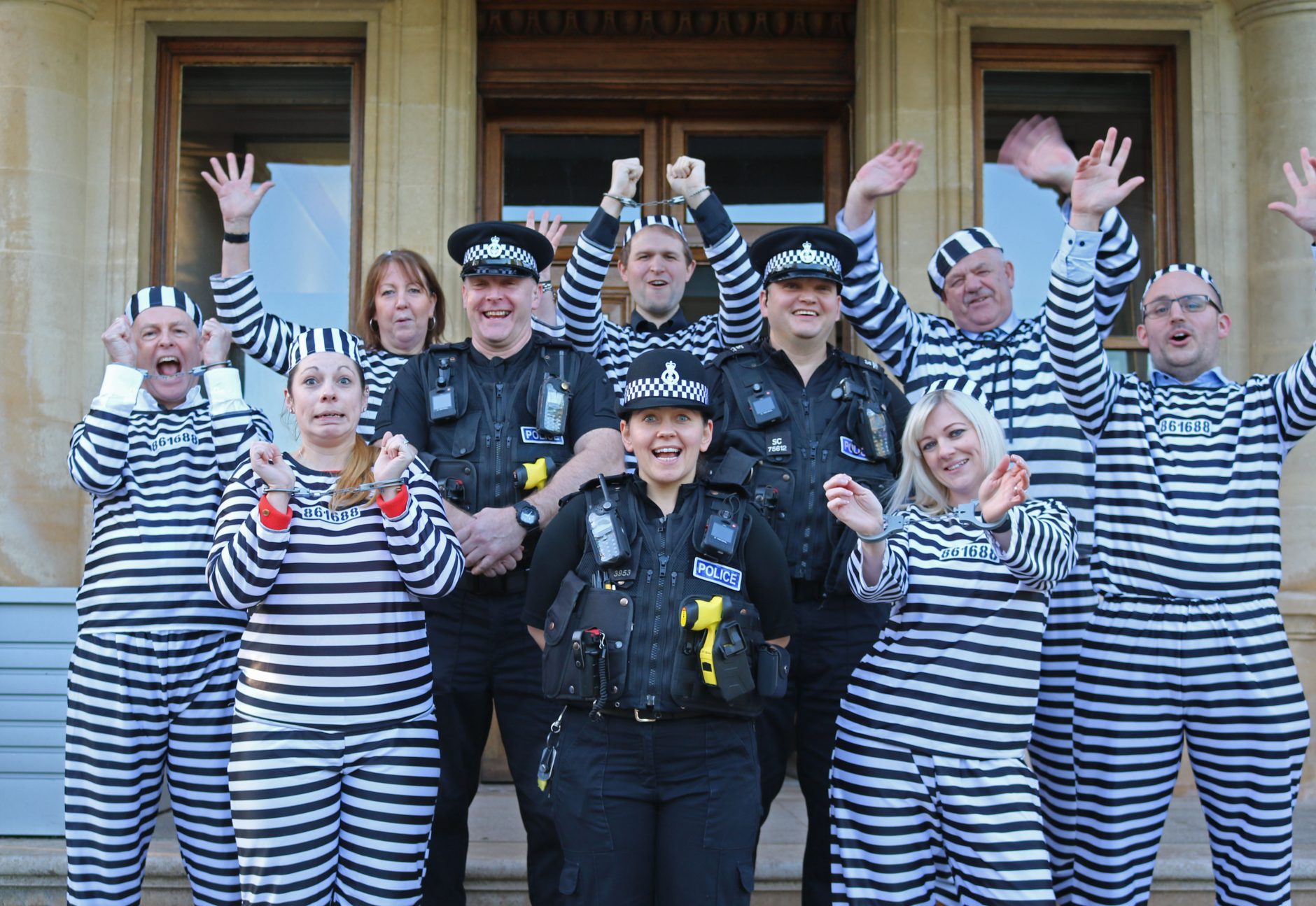 Fundraisers pose as convicts with Devon police officers in aid of Rowcroft.