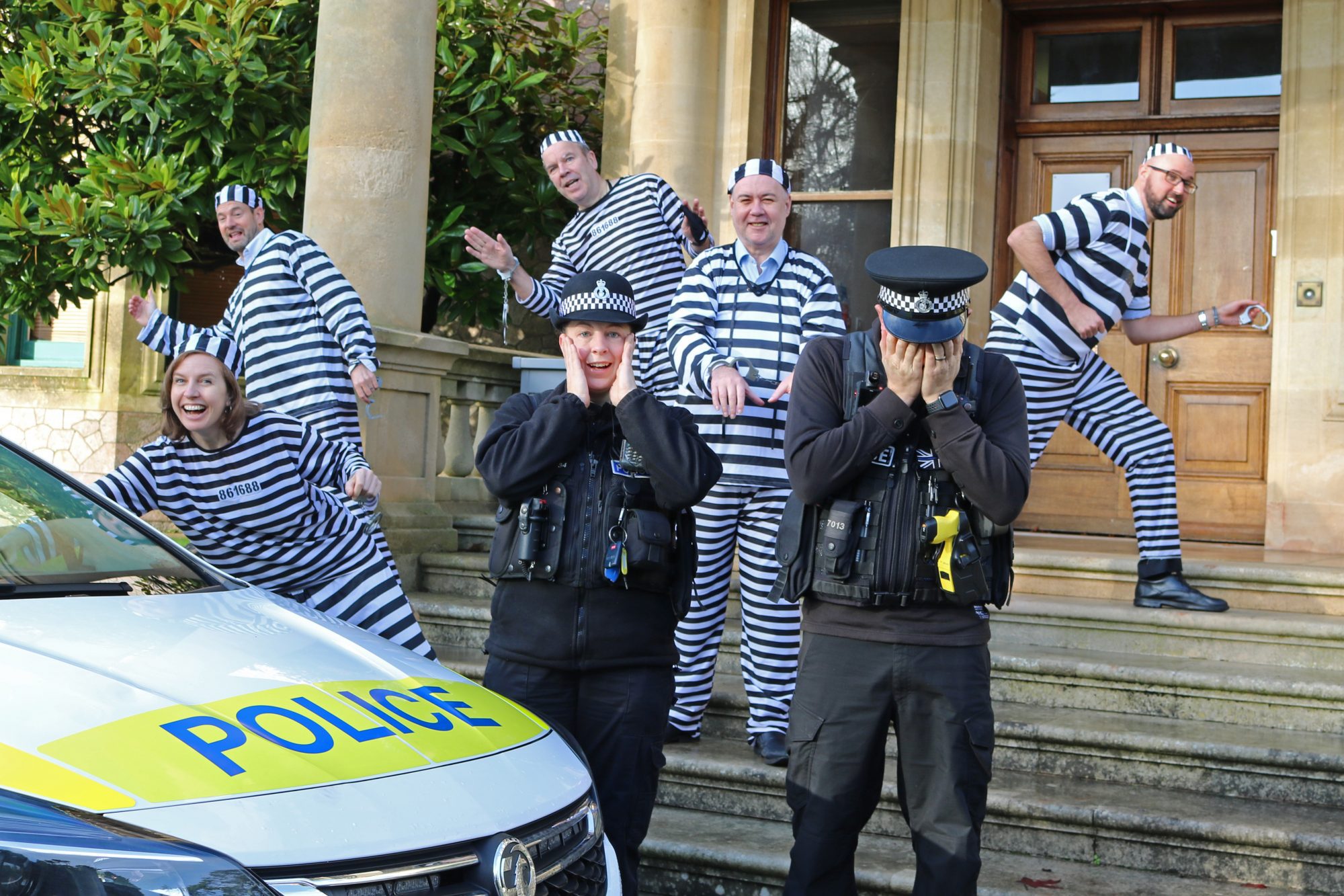 Local business people dress up in convict outfits with local police.