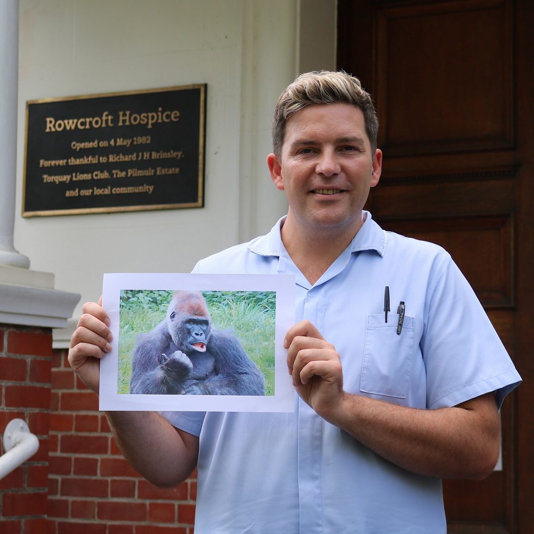 Keiron poses with a photo of a Gorilla.