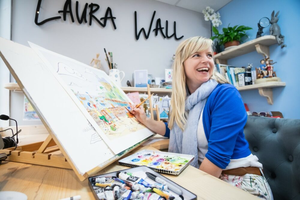 Laura Wall sat painting