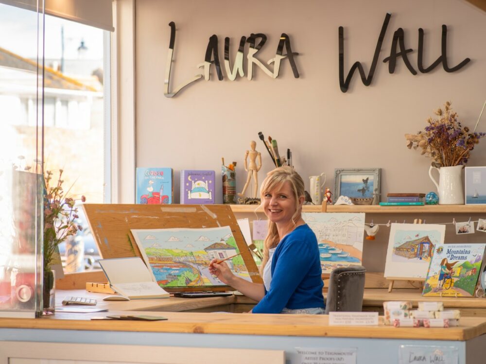 Laura Wall painting in her art studio