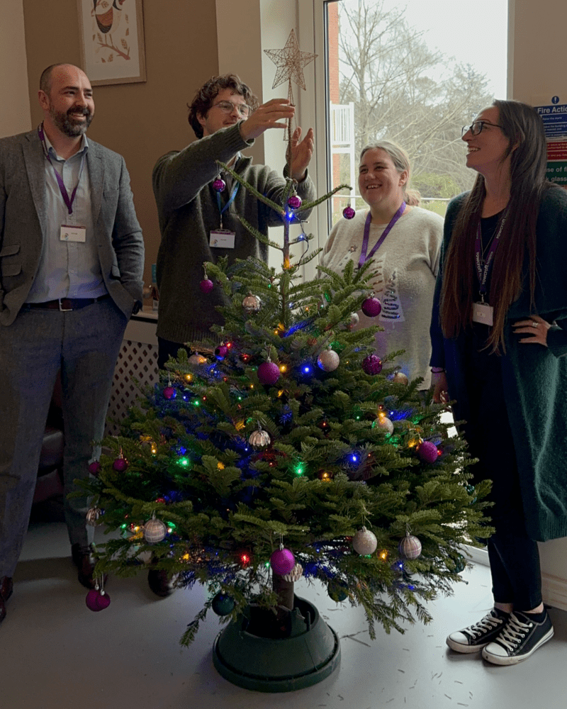 Orestone team putting the star on top of their Christmas tree.