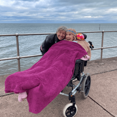 A patient with her carer on Teignmouth sea front.