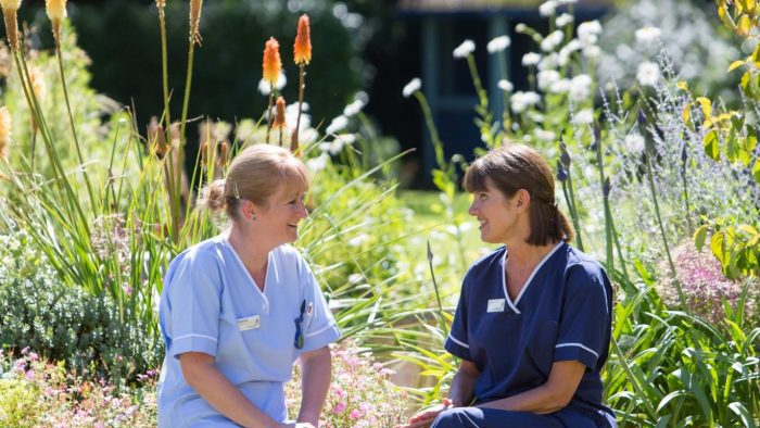 Two nurses sat in Rowcroft's gardens.