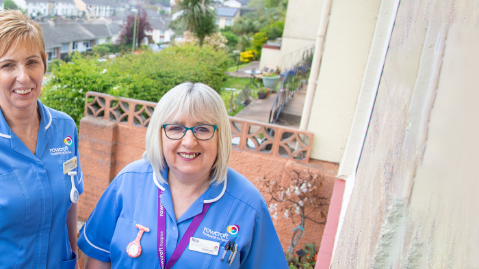 Rowcroft clinical staff members pose outside someone's door.