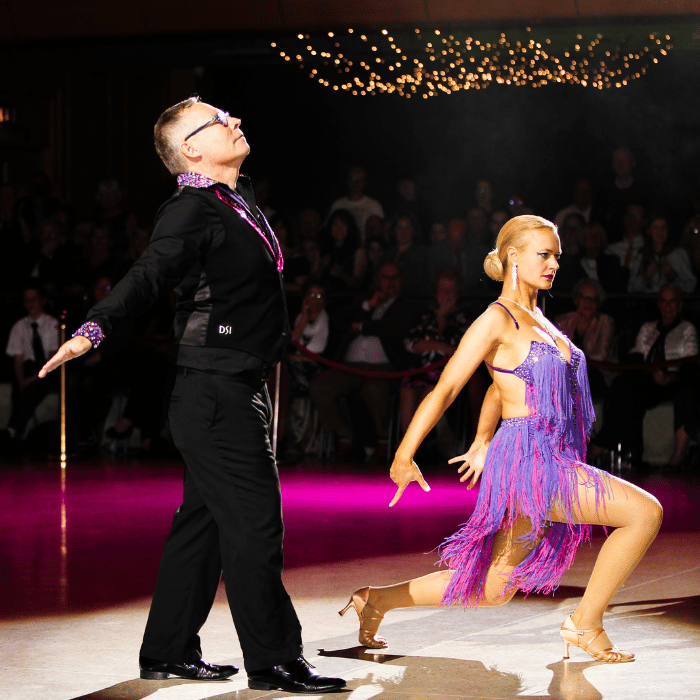 A couple pose on the dance floor