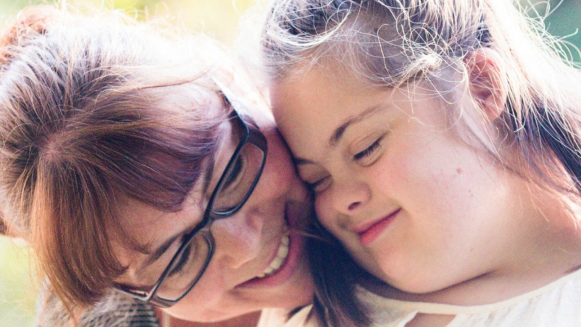 Mother and daughter cuddling.