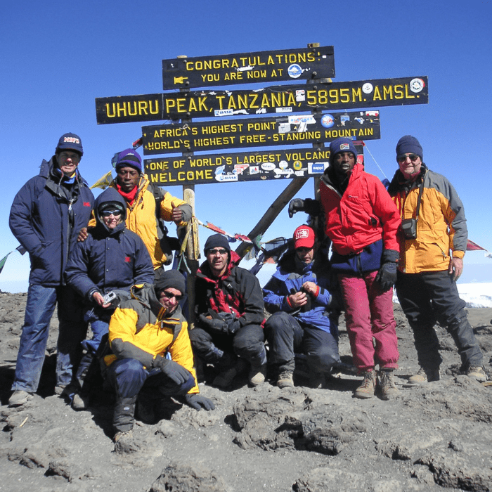 A team huddle on top of Kilimanjaro.