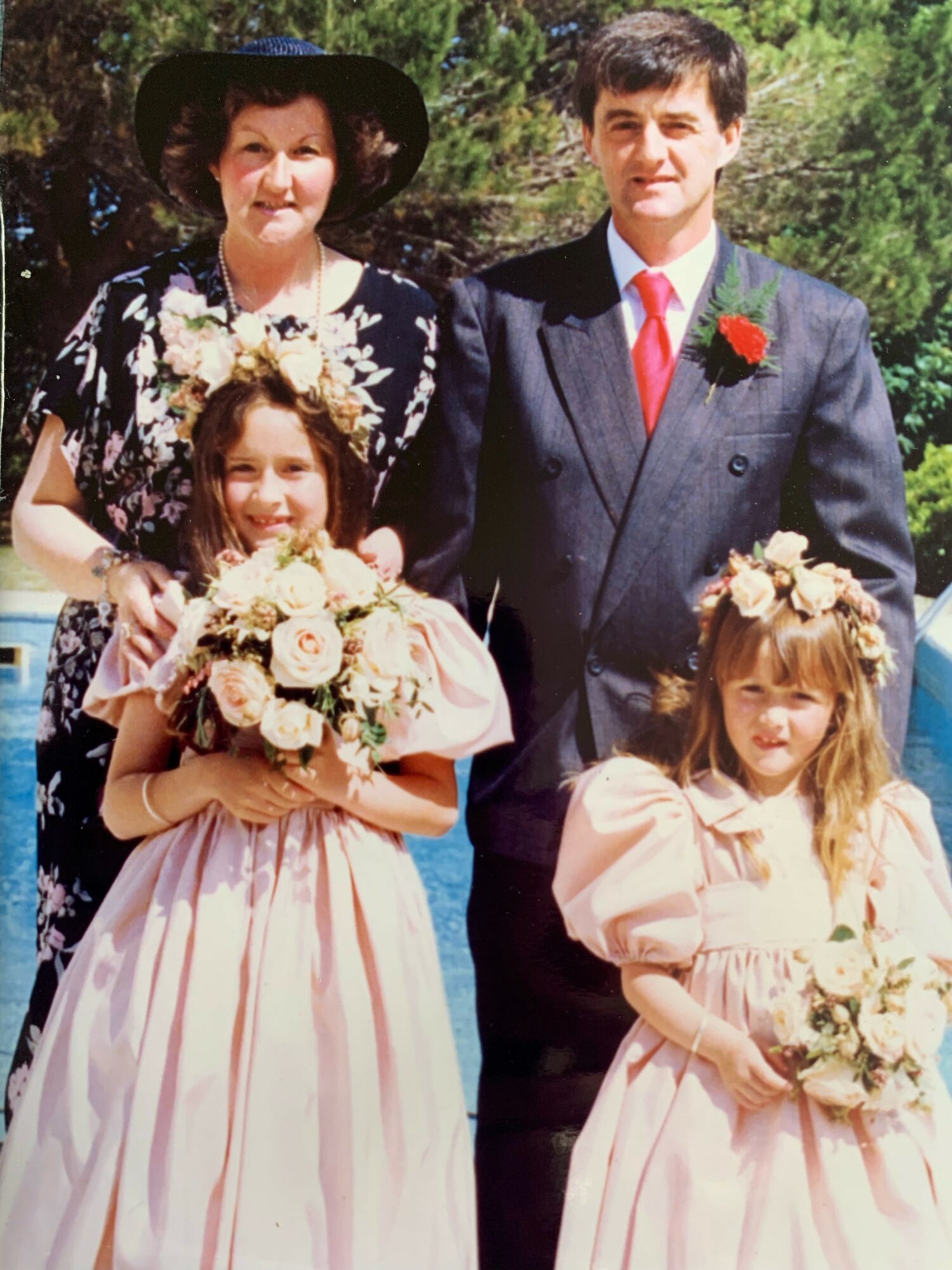 Tracy Thomas as a young bridesmaid (left), pictured with her younger sister Paula, and her mum and dad.