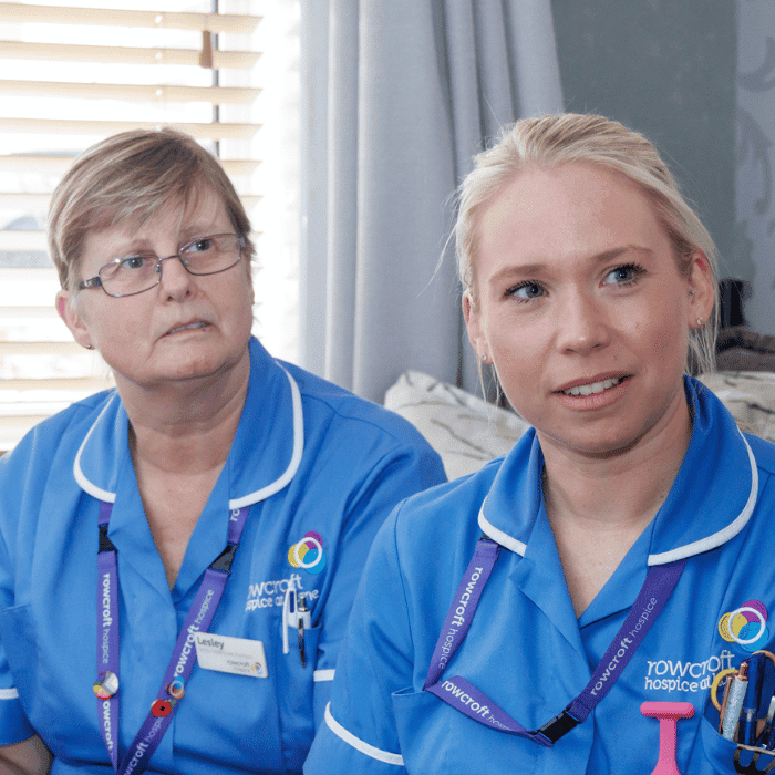 Two Rowcroft nurses sat on a settee