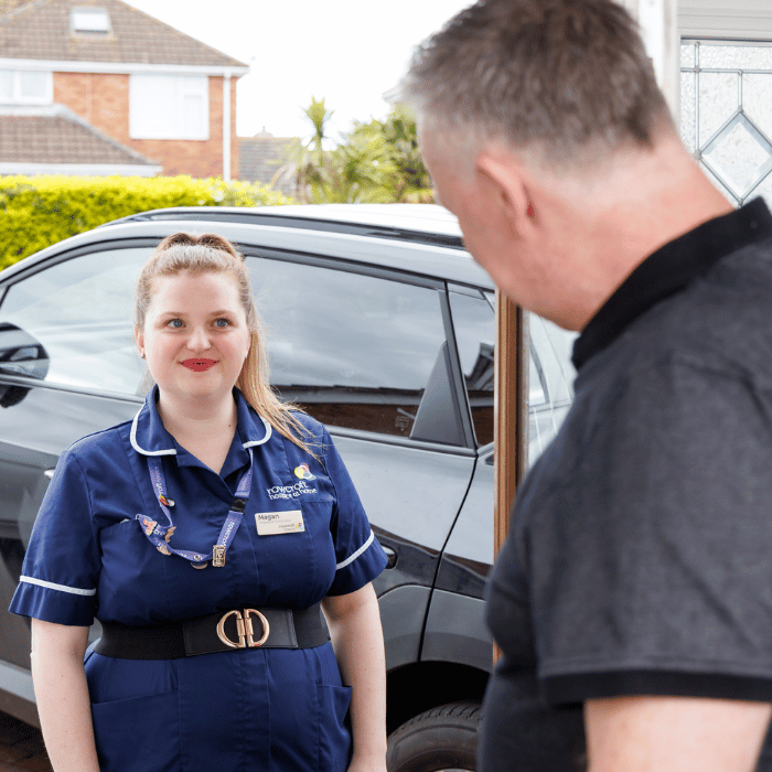 A Rowcroft nurse stood beside their car