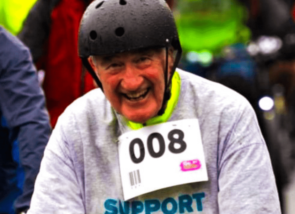A Ride for Rowcroft participant smiles for a photo. He is wearing a black helmet.