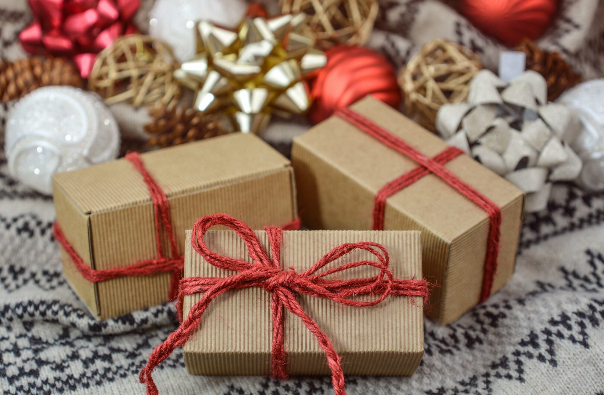 Christmas gifts surrounded by baubles and ribbons.