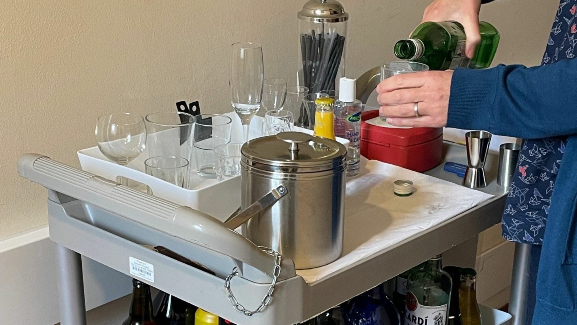 Volunteer pouring a drink from our drinks trolley.