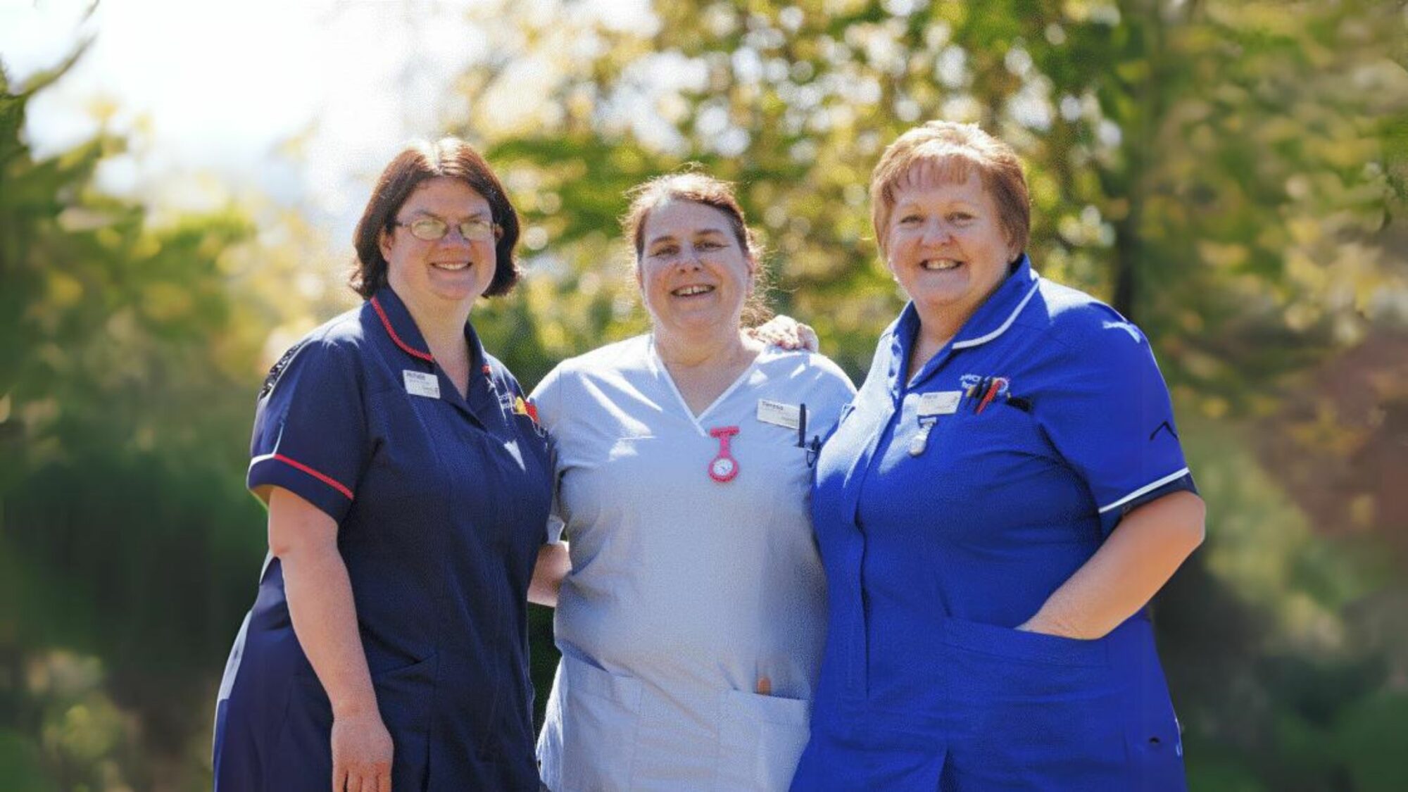 Three Rowcroft nurses smiling at camera.