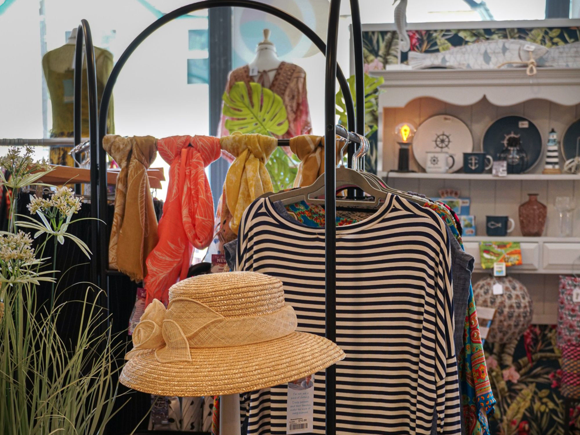 Image of a Rowcroft shop with striped top and a hat visible.