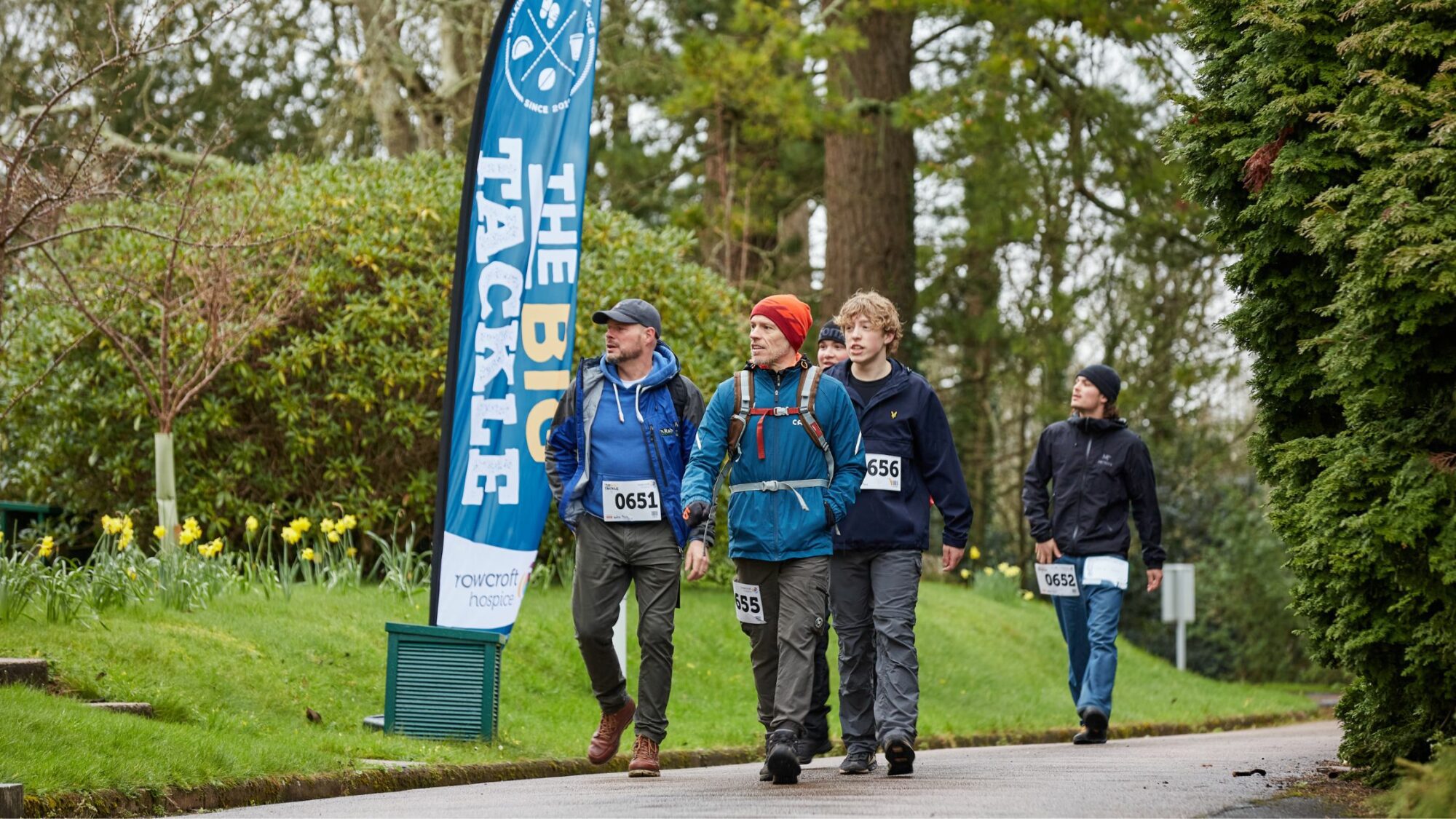 A group of Big Tackle participants walking at Rainbow House.